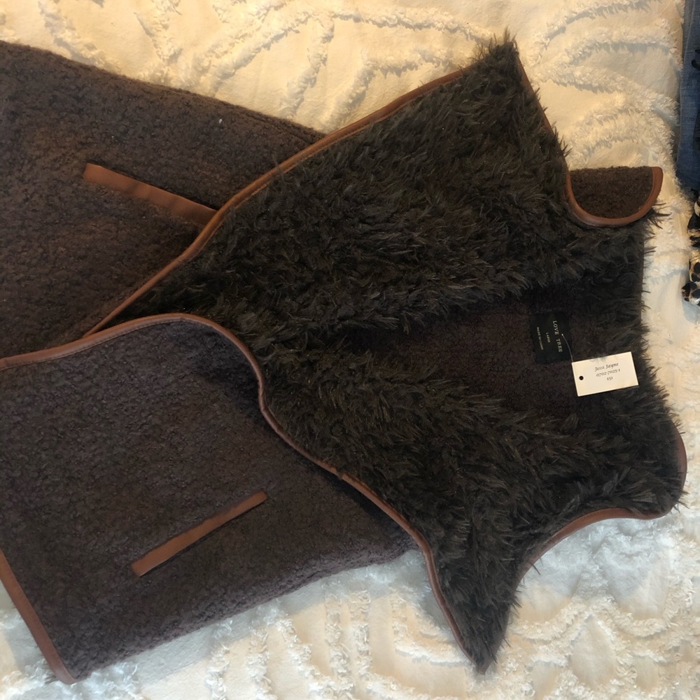 Faux fur vest with “leather” accents.